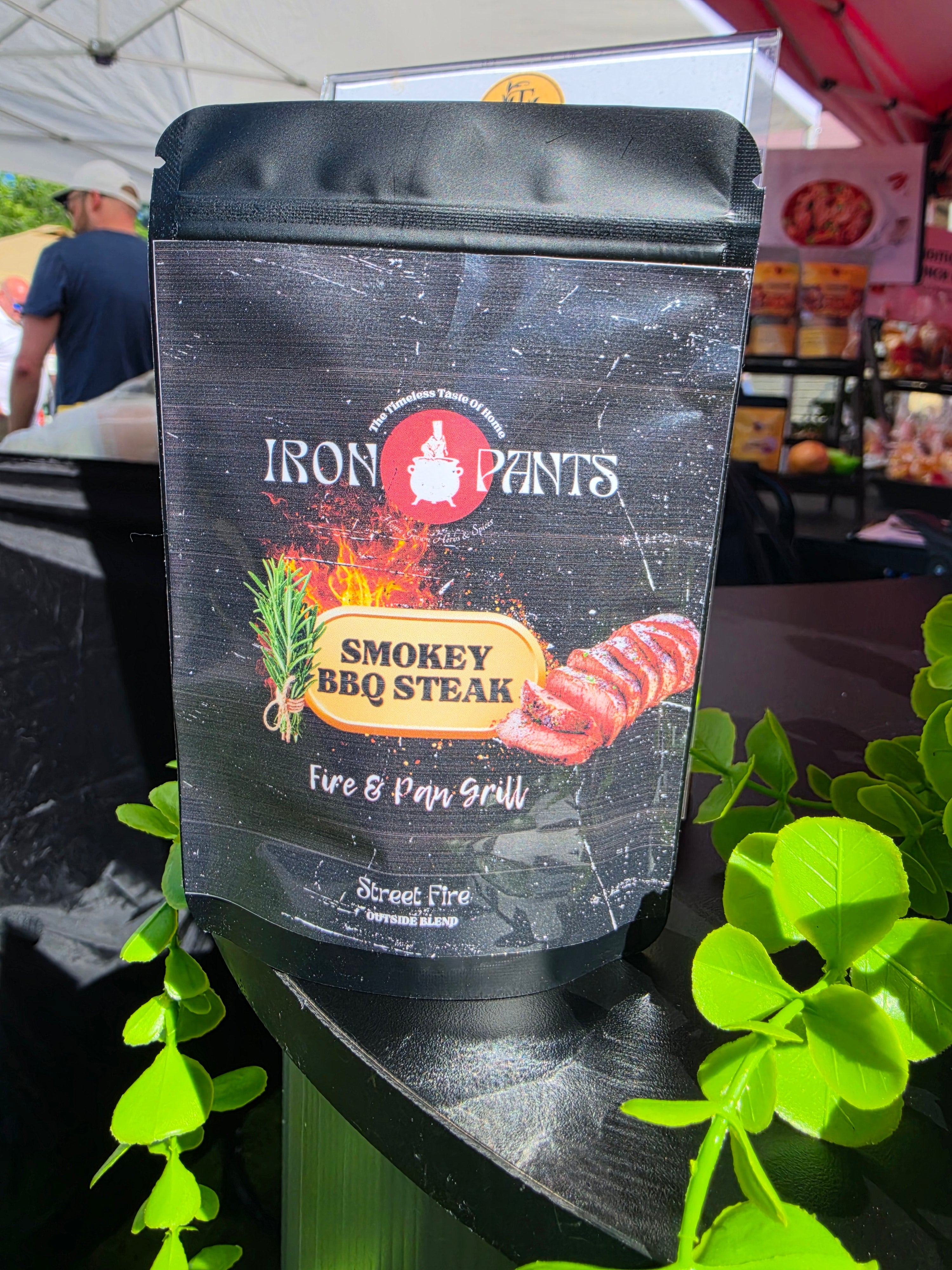 Iron Pants Smokey BBQ Steak seasoning pouch displayed at a market stall