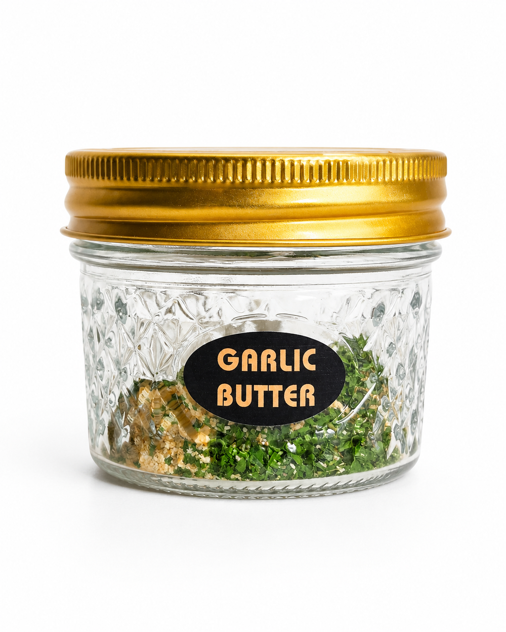 Jar of garlic butter with a gold lid on a white background