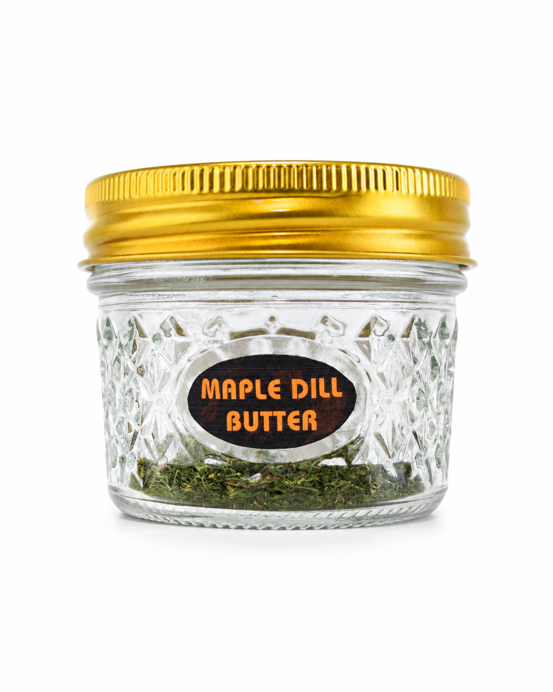 Jar of maple dill butter with a gold lid on a white background