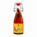 Bottle of Wicked Chilli Oil with a yellow label on a white background