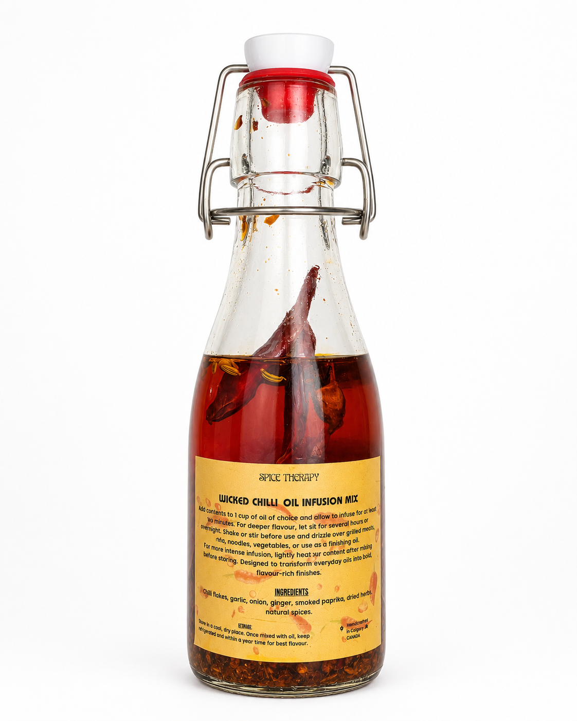 Bottle of infused oil with a white cap on a white background