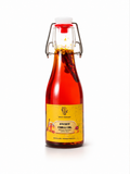 Bottle of sweet chili oil with a yellow label on a white background